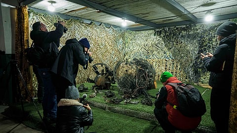 Journalists at a centre for forensic analysis in an undisclosed location in Ukraine on Nov. 24, 2024, film fragments of what authorities in Kyiv described as a Russian hypersonic missile that struck a factory in Dnipro, Ukraine, on Nov. 21.