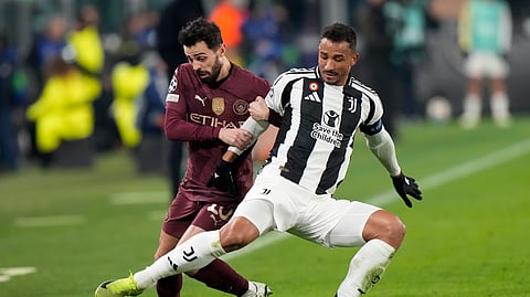 Manchester City's Bernardo Silva, left, and Juventus' Danilo fight for the ball during the Champions League, opening phase football match between Juventus and Manchester City at the Allianz stadium in Turin, Italy.