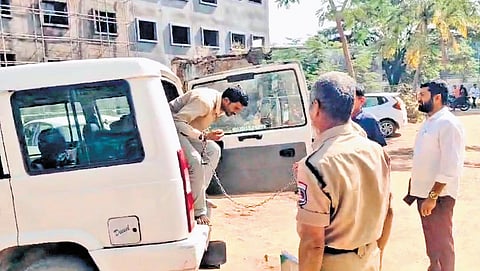 A handcuffed Lagcherla farmer, Hirya Nayak being shifted to hospital in Sangareddy