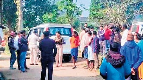 Locals gather near the police team investigating the murder in Jhirdapali