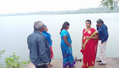 Officials inspecting the Thenkaraikottai lake where the bund of the lake observed a crack. 