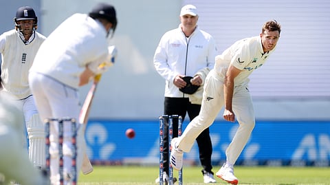 New Zealand's Tim Southee (R) bowls on day two of the second Test cricket match between New Zealand and England at the Basin Reserve in Wellington on December 7, 2024.