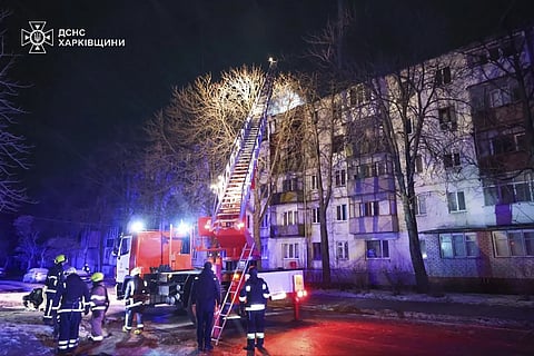 In this photo provided by the Ukrainian Emergency Service, firefighters work on the site of a damaged building after a Russian drone attack in Kharkiv, Ukraine, early Friday, Dec 13, 2024.