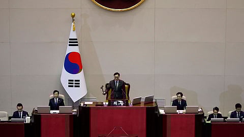 South Korean National Assembly Speaker Woo Won-shik bangs the gavel to initiate the plenary session for the impeachment vote of President Yoon at the National Assembly in Seoul on Saturday.