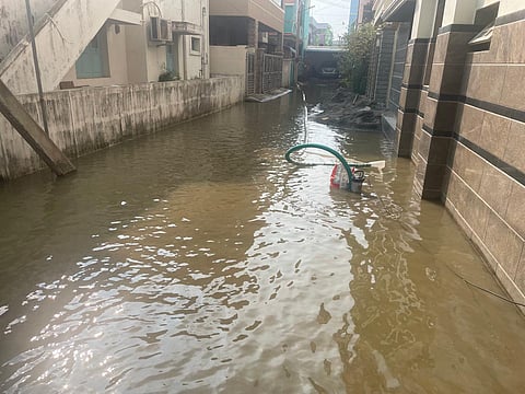 Residents of Gopalapuram 3rd Cross Street use their motor-pump to pump out floodwater