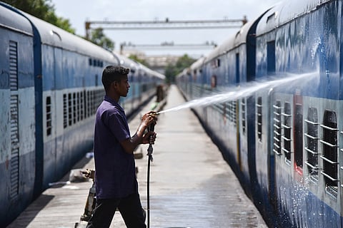 A train at a pitline in the Tiruchy coaching depot getting cleaned 
