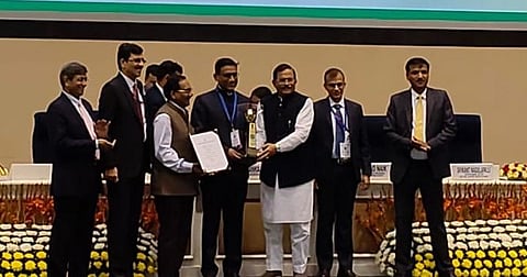 Senior IAS officer Dr Nilesh Deore (centre) receiving the award