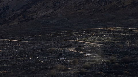 An Israeli bulldozer maneuvers on the buffer zone near the so-called Alpha Line that separates the Israeli-controlled Golan Heights from Syria, viewed from the town of Majdal Shams on Monday.