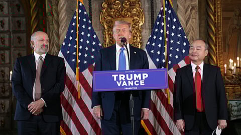 President-elect Donald Trump speaks during a news conference at Mar-a-Lago, Monday, in Palm Beach, Florida, as SoftBank Group CEO Masayoshi Son, right, and Commerce Secretary nominee Howard Lutnick listen.