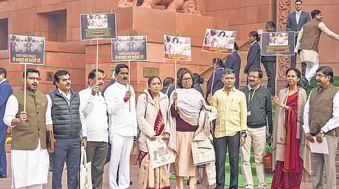 Maharashtra Congress leader Varsha Gaikwad and party MPs stage a protest over the killing of Sarpanch Santosh Deshmukh, in the Parliament House Complex in Delhi on Tuesday.