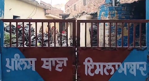 Police personnel and others stand near the body of one of the three terror suspects who, allegedly involved in the grenade attack in Gurdaspur, were killed in an encounter with a joint team of Uttar Pradesh and Punjab police, at a hospital, in Pilibhit.