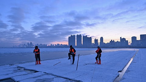 Workers harvest ice from the frozen Songhua river in preparation for the annual Harbin Ice and Snow World festival in Harbin, China’s northeast Heilongjiang province on December 17, 2024. (AFP)