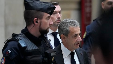 Former French President Nicolas Sarkozy arrives at the courtroom for his appeal trial of trying to bribe a magistrate in exchange for information about a legal case in which he was implicated Monday, Dec. 5, 2022 in Paris.