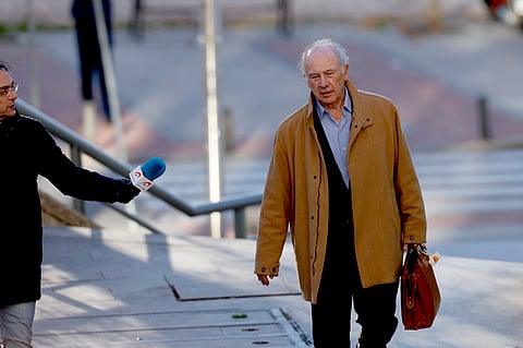 Former IMF chief, former Spanish Economy Minister and former president of Caja Madrid bank Rodrigo Rato, accused of tax evasion and corruption, walks past a journalist as he arrives for his trial at Madrid's Court of Justice on December 15, 2023. 