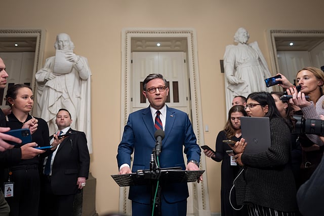 Speaker of the House Mike Johnson, R-La., talks briefly to reporters just before a vote on an interim spending bill to prevent a government shutdown, at the Capitol in Washington on Thursday.