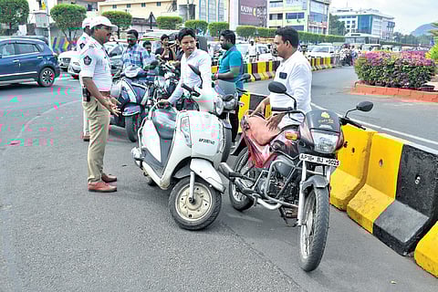 Traffic police intercept commuters without helmets in Vijayawada