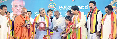 CM Siddaramaiah launches the 87th Kannada Sahitya Sammelana stamp and book in Mandya on Friday 