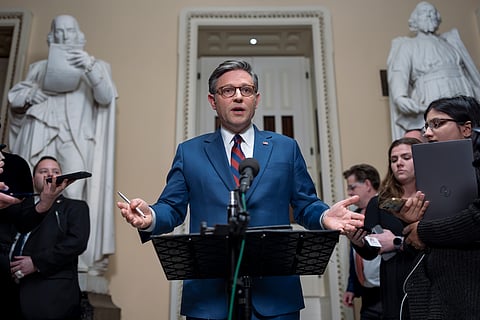 Speaker of the House Mike Johnson, R-La., talks briefly to reporters just before a vote on an amended interim spending bill to prevent a government shutdown, at the Capitol in Washington, Thursday, Dec. 19, 2024.