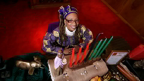 The candles are the same colors as the Kwanzaa flag: Black representing the people, red their struggle and green their hope.