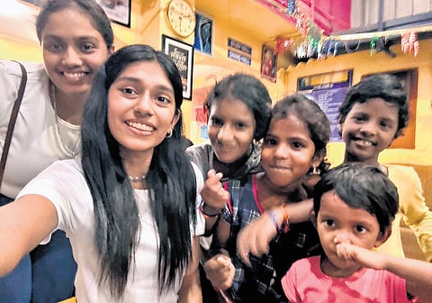 Aditi and Neha with the children of New Hope New Life Orphanage.