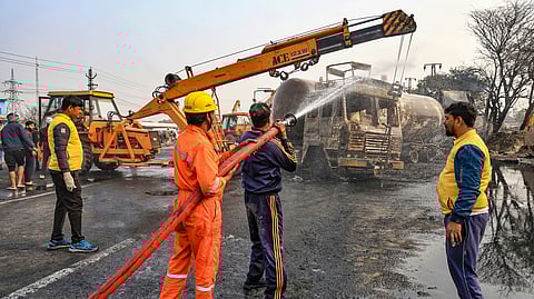 Firefighters douse the fire at the site of the accident after a truck loaded with a chemical collided with some other vehicles and caught fire on the Jaipur-Ajmer Highway, in Jaipur, Friday, Dec. 20, 2024.