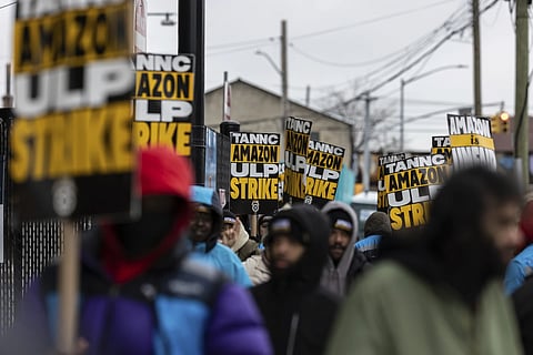 Amazon workers and members of the International Brotherhood of Teamsters picket in front of the Amazon fulfilment center in the Queens borough in New York, on Friday, Dec 20, 2024.