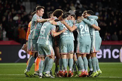 Atletico Madrid players celebrate after scoring their second goal during the Spanish league football match between FC Barcelona and Club Atletico de Madrid on December 21, 2024. 
