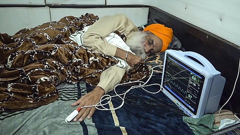 Farmer leader Jagjit Singh Dallewal rests during his hunger strike at the Khanauri border.