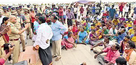 Fisher families from Nochikuppam blocked a road in the area with a boat to register their protest against the GCC’s blue flag beach project on Tuesday | P Ravikumar
