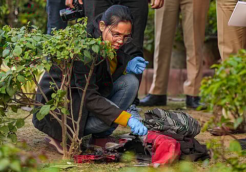 A member of the forensic team of Delhi Police Crime Branch conducts investigation at the spot where a man tried to immolate himself near the Railway Bhawan opposite the new Parliament building, in New Delhi, Wednesday, Dec. 25, 2024. 