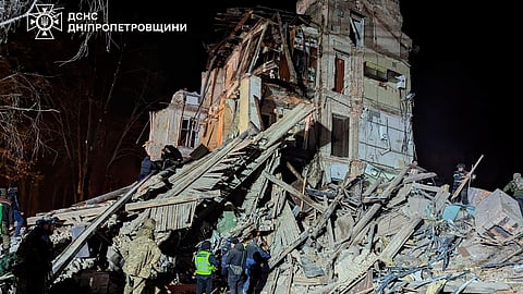 In this image provided by the Ukrainian Emergency Service on Wednesday, Dec. 25, 2024, firefighters work on a site of an apartment building destroyed by a Russian attack in Kryvyi Rih, Ukraine.