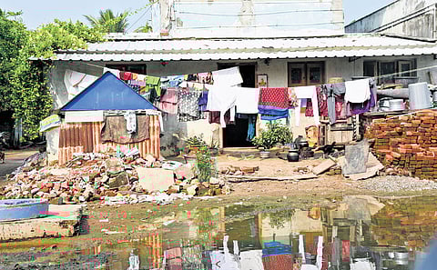 Another house in a dilapidated condition; women pay tribute to the victims of the tsunami, at the Marina Beach on Thursday. 
