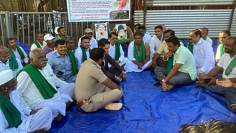 Deputy Commissioner Mohammad Roshan discussing with the farmers agitating in front of the Deputy Commissioner’s office, in Belagavi on Thursday. SP Bhimashankar Guled looks on.