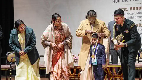 President Droupadi Murmu confers a Pradhan Mantri Rashtriya Bal Puraskar to Anish Sarkar, at the Rashtrapati Bhavan Cultural Centre in New Delhi on Thursday.