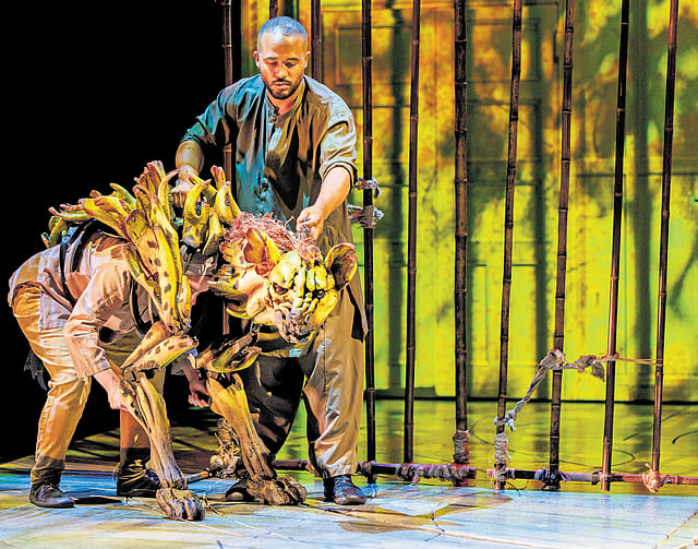 Two puppeteers  manoeuvring the tiger