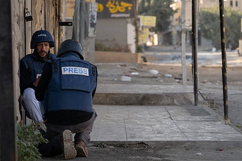 Journalists take cover from gunfire as Palestinian security forces mount a major raid against militants in the Jenin refugee camp in the Israeli-occupied West Bank, Monday, Dec. 23, 2024. ( Representative purpose)