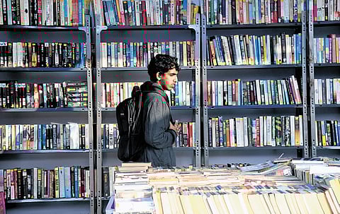 A young visitor checks out a stall at the Hyderabad Book Fair on Friday