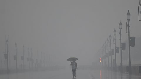 People use umbrella to protect themself from rain in New Delhi