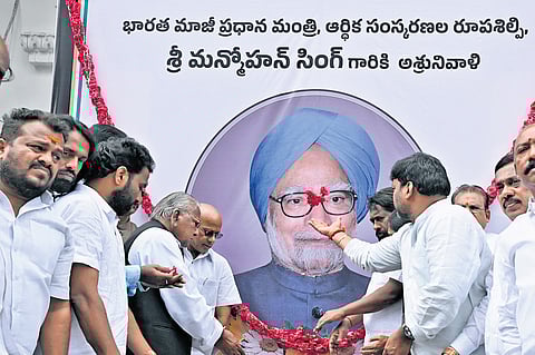 Congress leaders pay tributes to a portrait of former prime minister Manmohan Singh at the Gandhi Bhavan on Friday. A file picture (right) of former CM YS Rajasekhara Reddy and Manmohan Singh at the foundation stone laying  ceremony for the Outer Ring Road .