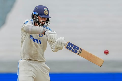 India's Washington Sundar hits a boundary during play on the third day of the fourth cricket test between Australia and India.