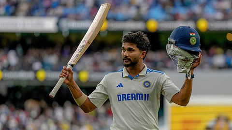 India's Nitish Kumar Reddy acknowledged the crowd as he walked off the field after bad light stopped play during play on the third day of the fourth cricket test between Australia and India at the Melbourne Cricket Ground, Melbourne.