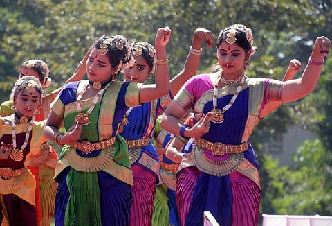Artists perform traditional dance during the launching of Mysuru cinema festival in Mysuru.