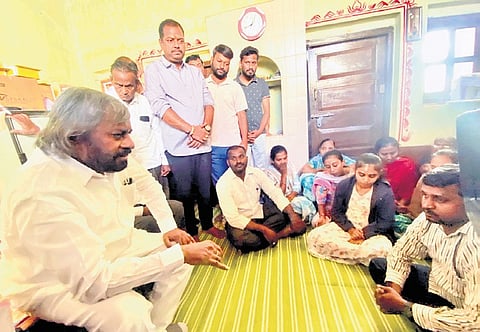 Bidar district in-charge minister Eshwar Khandre interacts with the relatives of contractor Sachin Panchal, during a visit to their residence on Sunday