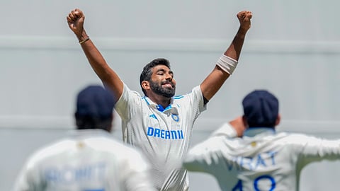 India's Jasprit Bumrah celebrates with teammates after the wicket of Australia's Mitchell Marsh during play on the day four of the fourth cricket test between Australia and India at the Melbourne Cricket Ground.