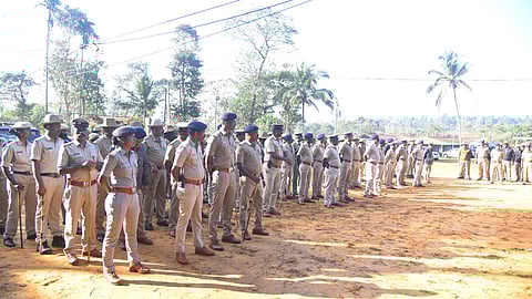 Police stand guard outside the Mrityunjaya Temple premises. 