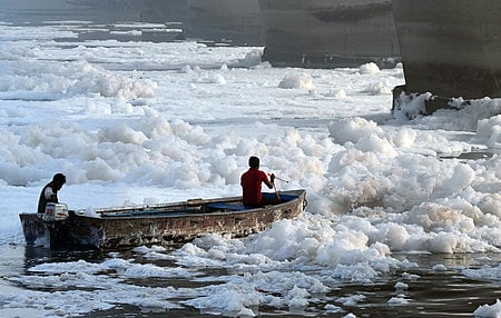 File | Workers spray chemicals to dissolve toxic foam in the polluted Yamuna river at Kalindi Kunj during 'Chhath'' festival, in New Delhi, 2024. 