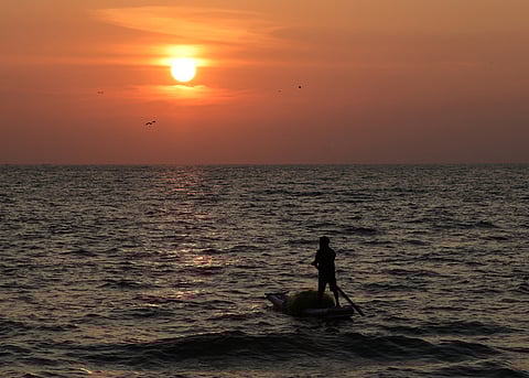 A fisherman sets sail into the ocean, seeking a bountiful catch.