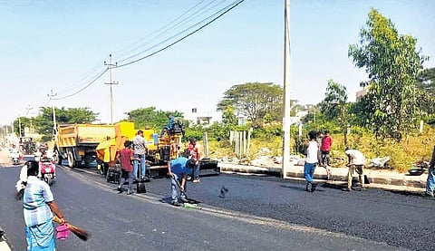 BBMP staffers fill potholes on Begur Road near Bommanahalli on Wednesday