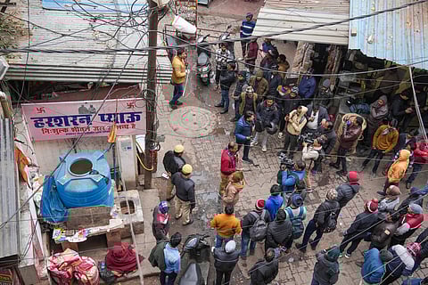 Media persons outside a hotel after five members of a family were found dead here, in Lucknow, Wednesday, Jan. 1, 2025.