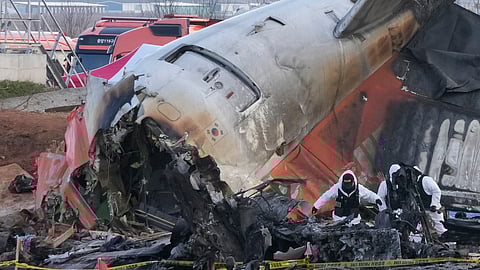 Rescue team members work at the site of a plane crash at Muan International Airport in Muan, South Korea. 